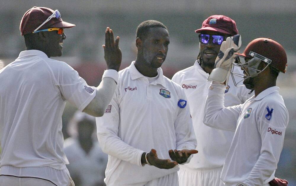 West Indian bowler Shane Shillingford celebrates the wicket of Indian batsman Murli Vijay during the 2nd test match played in Mumbai.