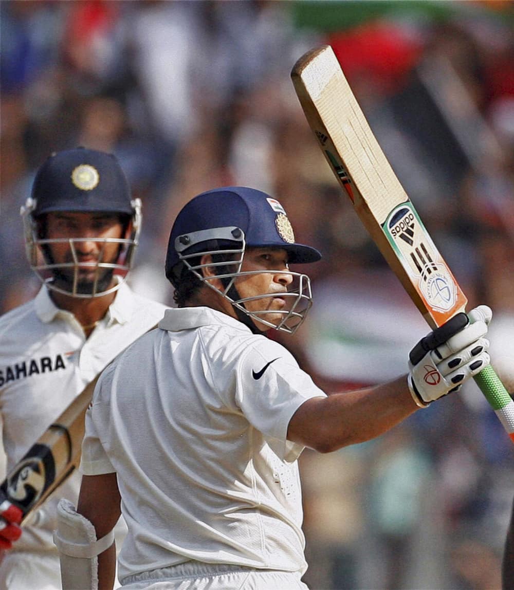 Master blaster Sachin Tendulkar raises his bat to acknowledge the crowd after his half century against West Indies on Day 2 of the final Test match at Wankhede Stadium in Mumbai.