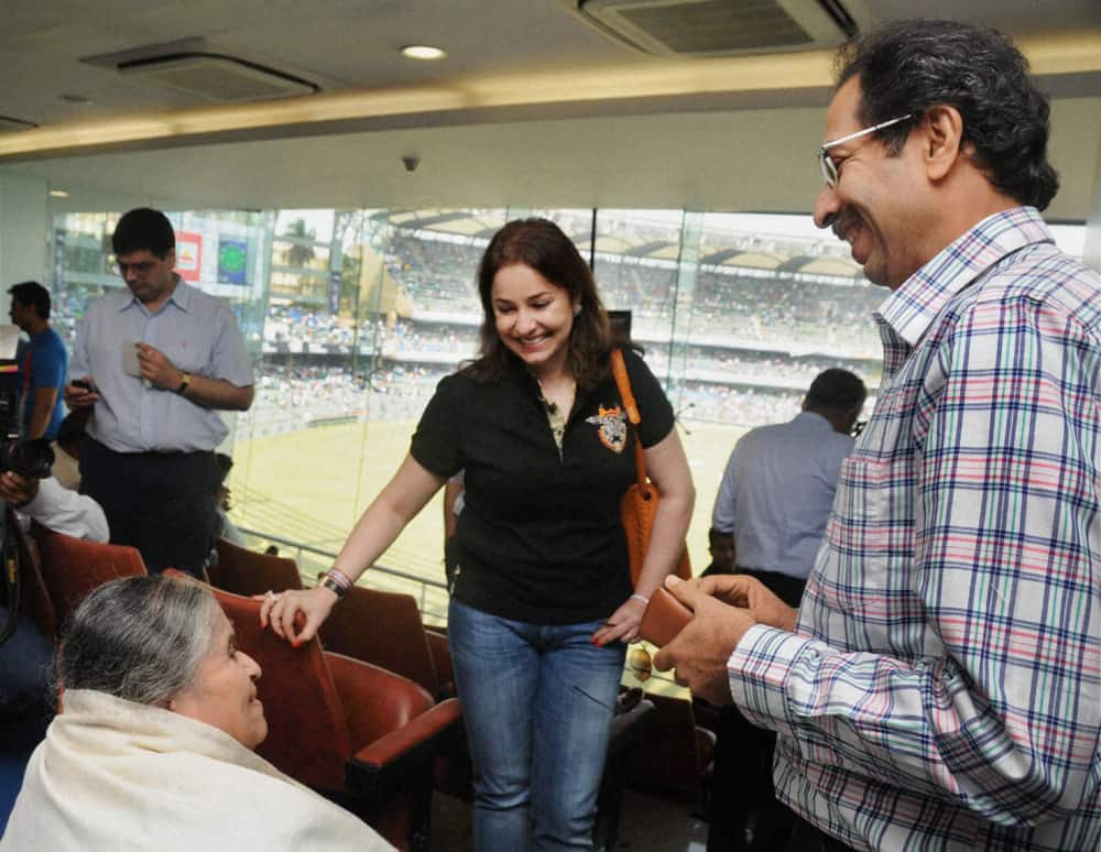 Shiv Sena Executive President Uddhav Thackeray (R) with Sachin Tendulkar's mother Rajni Tendulkar and wife Anjali at Wankhede Stadium on Day 2 of the final Test match between India and West Indies in Mumbai.