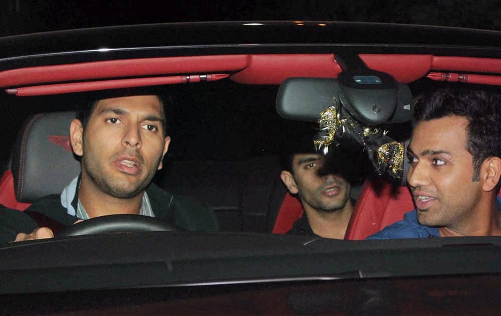 Cricketer Yuvaraj Singh and Rohit Sharma arrive at a farewell party hosted by Sachin and Anjali Tendulkar in Mumbai.