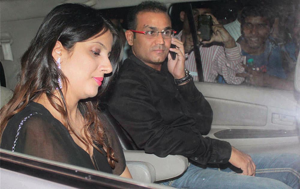 Cricketer Virender Sehwag along with his wife on their way to attend a farewell party hosted by Sachin and Anjali Tendulkar in Mumbai.