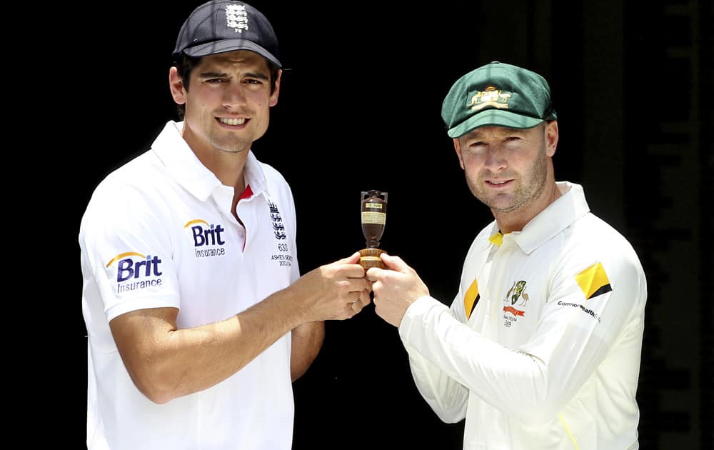 England captain Alastair Cook and Australian captain Michael Clarke pose with the replica of Ashes urn on the eve of the first test in the Ashes Series between England and Australia, in Brisbane, Australia.