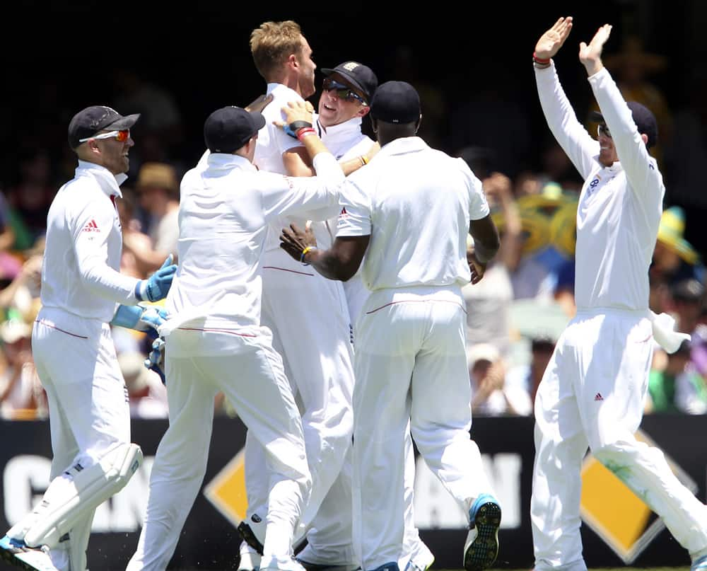 Stuart Broad celebrates with his teammates after he got the wicket of Australia's Shane Watson on the first day of the series-opening Ashes test between England and Australia at the Gabba in Brisbane, Australia.