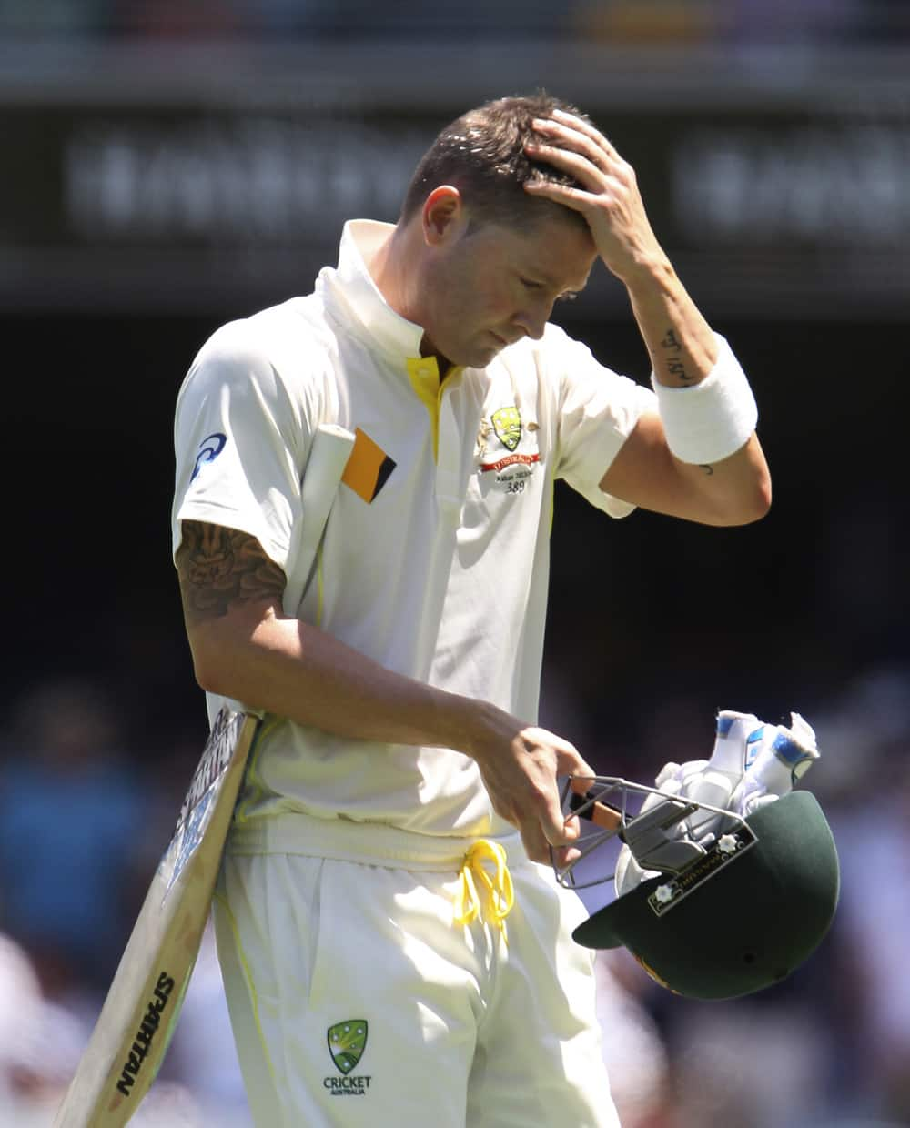 Australian captain Michael Clarke walks back to the dressing room after he lost his wicket for one run on the first day of the series-opening Ashes test between England and Australia at the Gabba in Brisbane, Australia.