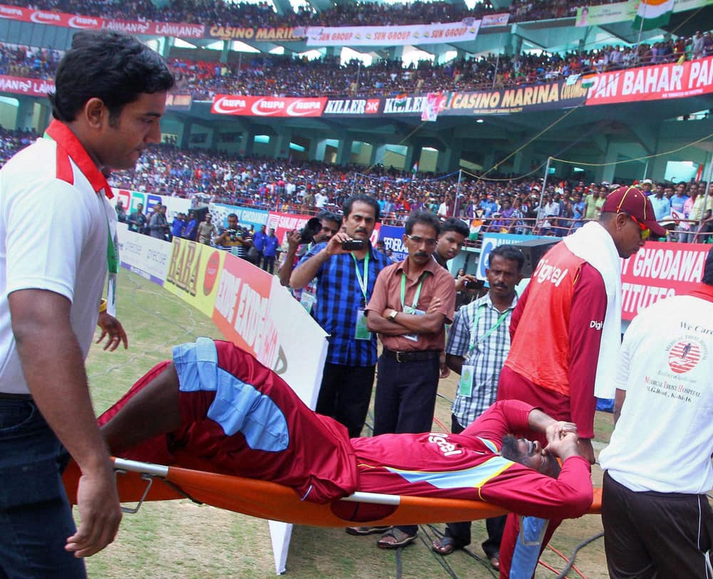 Chris Gayle of West Indies is taken out on a stretcher after he suffered an injury while completing a run during the 1st ODI cricket match against India at Jawaharlal Nehru Stadium in Kochi.