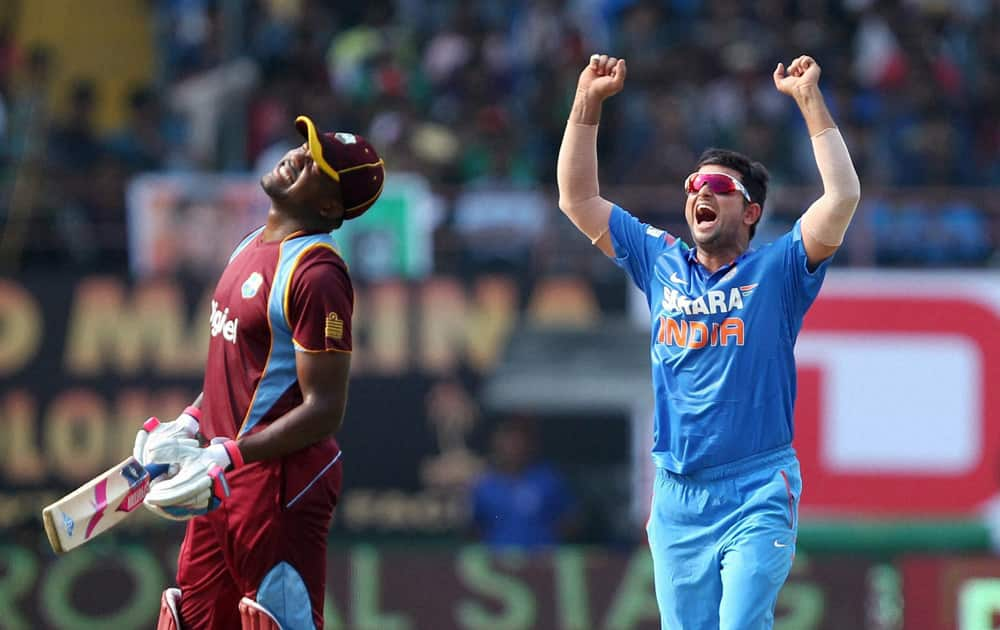 Suresh Raina celebrates the wicket of Lendl Simmons of West Indies during the 1st ODI in Kochi.