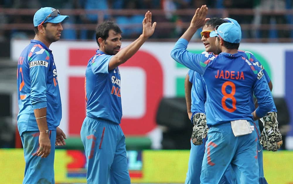 Shammi Ahmed with team mates celebrates the wicket of Darren Bravo of West Indies during the 1st ODI cricket match at Jawaharlal Nehru Stadium in Kochi.