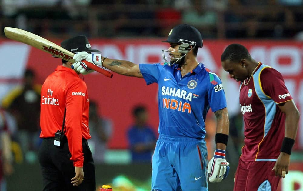 Virat Kohli celebrate his fifty runs against West Indies during the 1st ODI in Kochi.