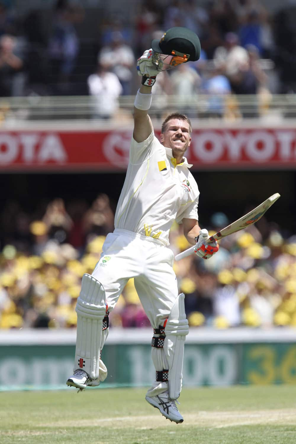 Australia's David Warner celebrates reaching his century on the third day of the series-opening Ashes cricket test between England and Australia at the Gabba in Brisbane, Australia.