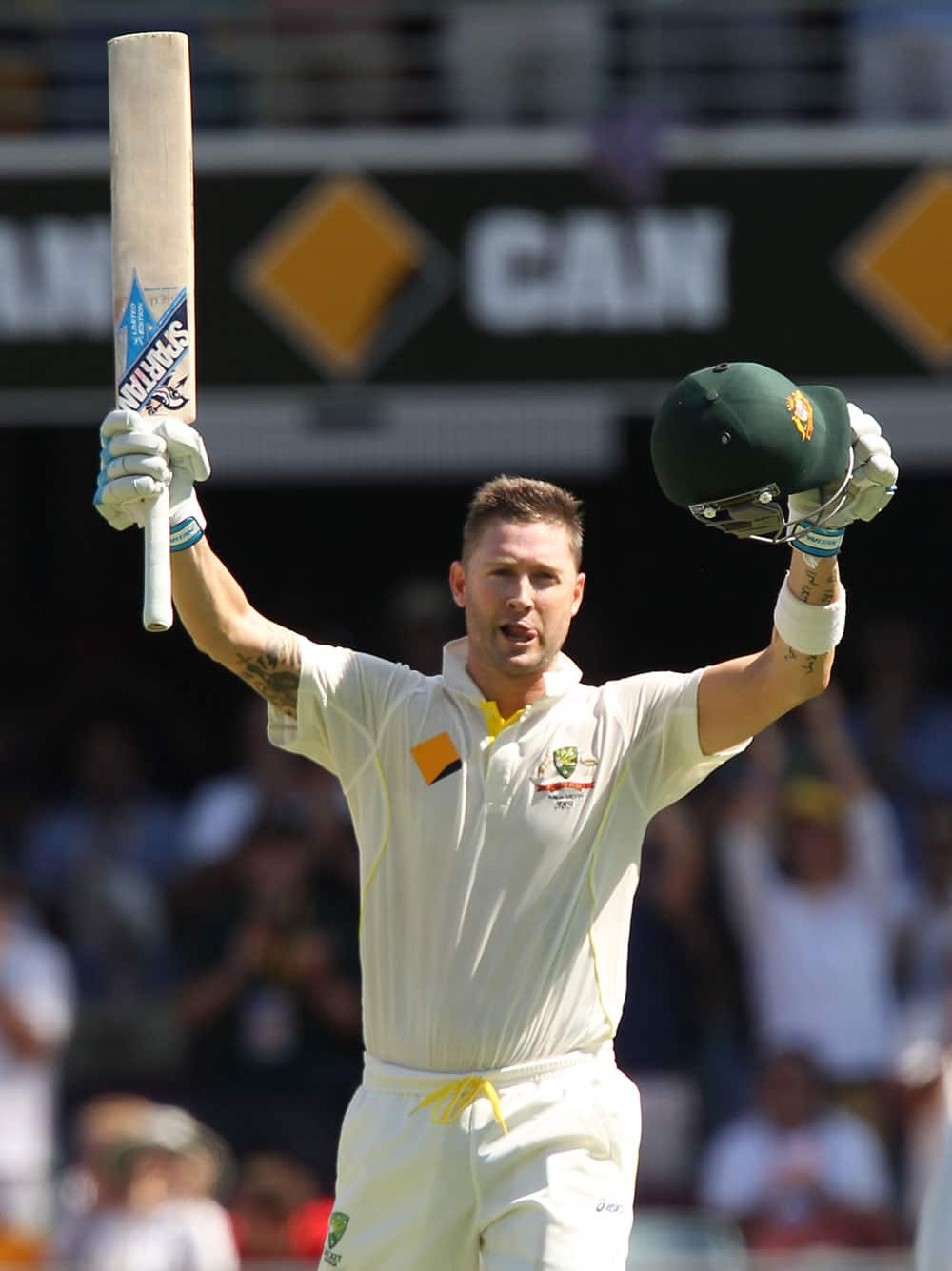 Australia's Michael Clarke celebrates as he reaches 100 runs on the third day of the series-opening Ashes cricket test between England and Australia at the Gabba in Brisbane, Australia.