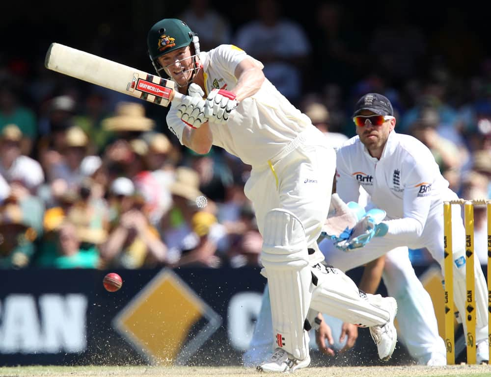 Australia's George Bailey plays a shot in front of England wicketkeeper Matt Prior, right, on the third day of their series-opening Ashes cricket test at the Gabba in Brisbane, Australia.