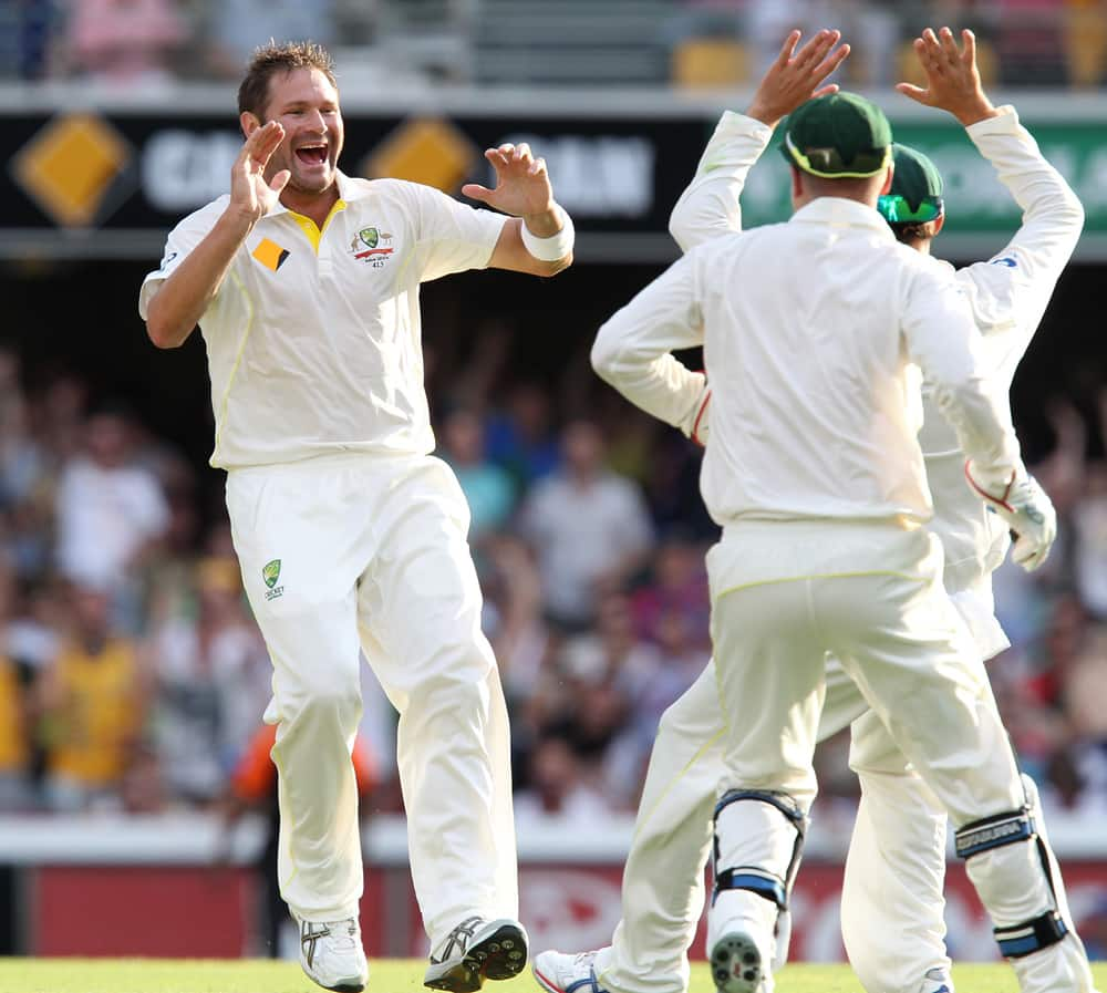 Ryan Harris celebrates after he got the wicket of Michael Carberry, on the third day of the series-opening Ashes cricket test at the Gabba in Brisbane, Australia.