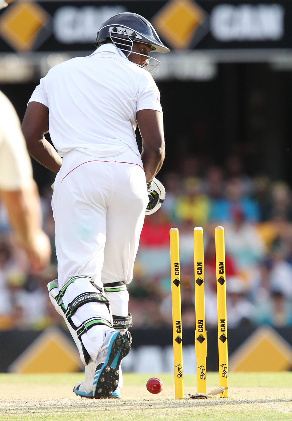 Michael Carberry looks back at his stumps after he was bowled out by Ryan Harris on the third day of the series-opening Ashes cricket test at the Gabba in Brisbane, Australia.