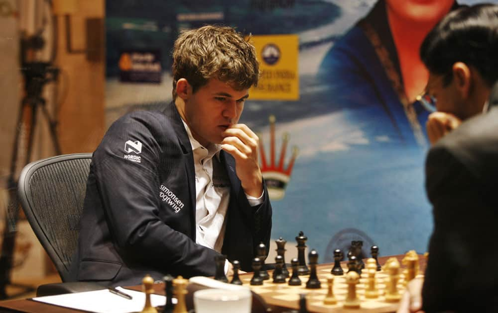 Norway's Magnus Carlsen, left, plays against reigning world chess champion India’s Viswanathan Anand during the Chess World Championship match in Chennai.