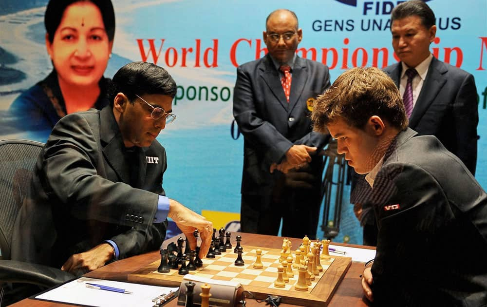 Defending champion India’s Viswanathan Anand, left, makes a move against Norway’s Magnus Carlsen during the first game of the World Chess Championship in Chennai.