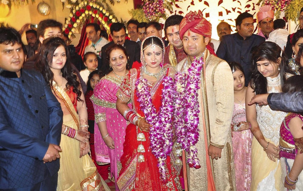 Piyush Chawla and Anubhuti Chauhan posing for photographers during their wedding ceremony in Moradabad.