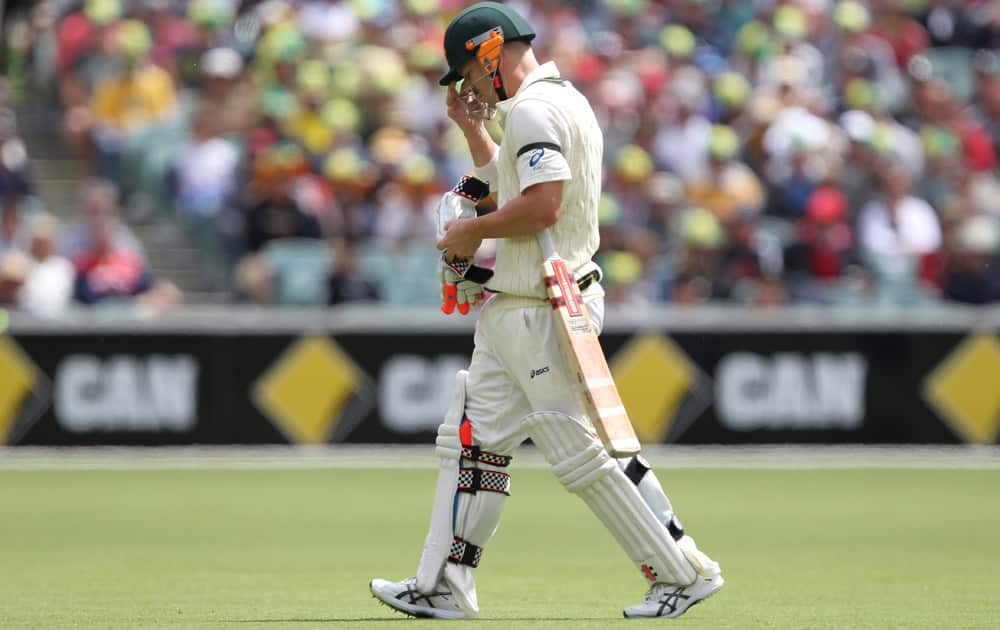 Australia's David Warner walks after losing his wicket during the second Ashes cricket test match between England and Australia, in Adelaide, Australia.