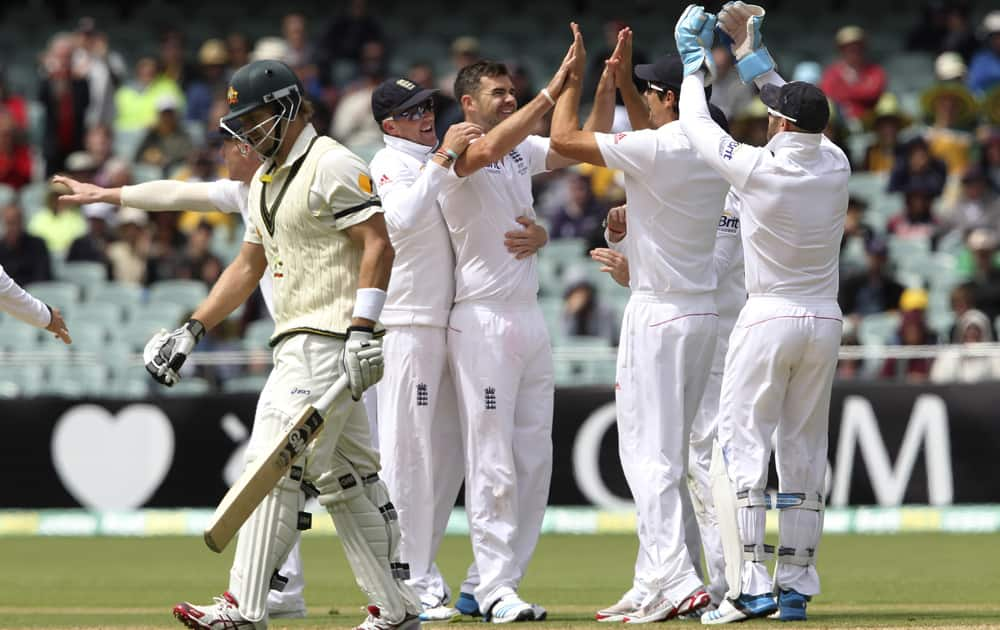 England players celebrate the wicket of Australia's Shane Watson during their second Ashes cricket test match in Adelaide, Australia.