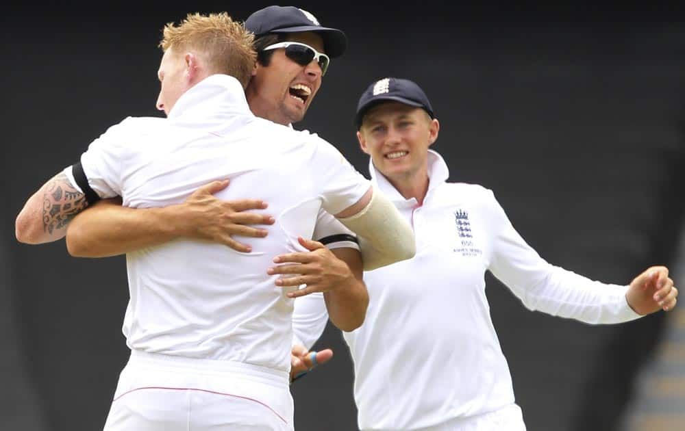 England's Ben Stokes, left, Alistair Cook, center, and Joe Root celebrate the wicket of Brad Haddin but was ruled a no ball and not out during the second Ashes cricket test match between England and Australia, in Adelaide.