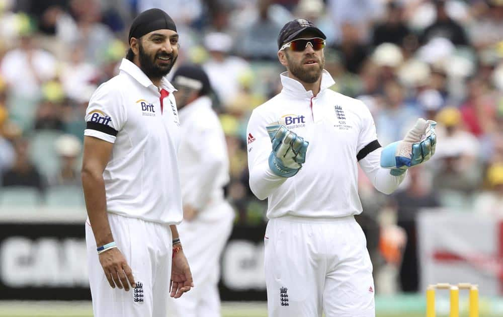 England cricket wicket keeper Matt Prior, right, waits to catch the ball as bowler Monty Panesar looks on during play on the second day of the second Ashes cricket test match against Australia in Adelaide.