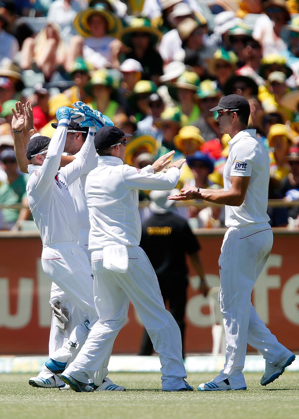 England's Kevin Pietersen is congratulated by team mates after taking the catch of Australia's George Bailey on the first day of the Ashes cricket test match in Perth, Australia.