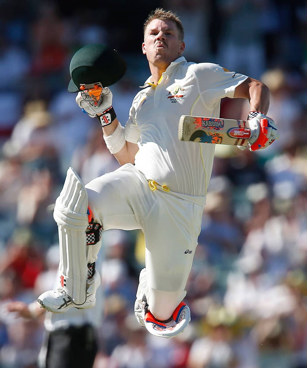 Australia's Dave Warner leaps into the air after scoring a century in the second innings on the third day of their Ashes cricket test match against England in Perth, Australia.