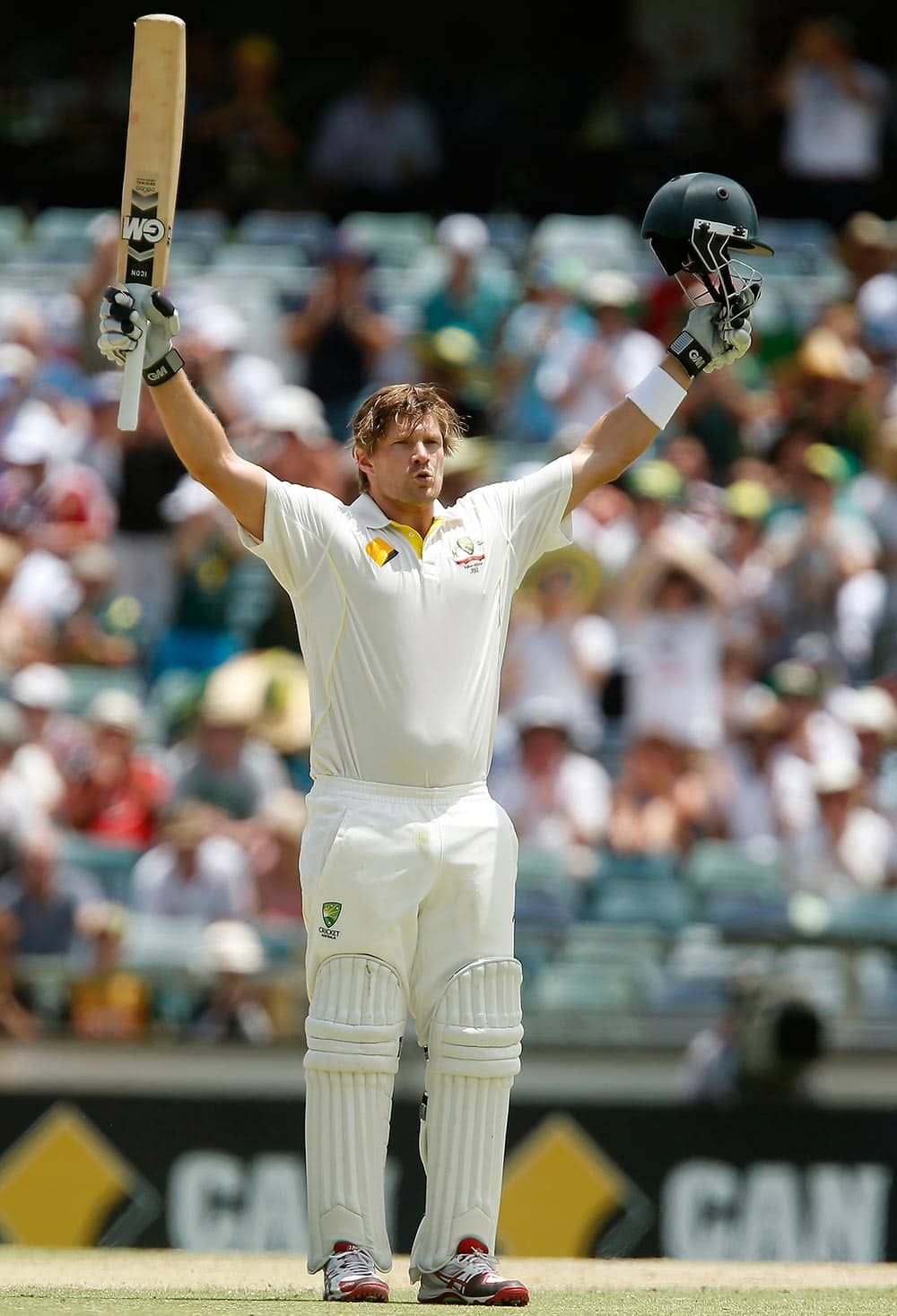 Australia's Shane Watson throws his arms up in celebration after scoring a test century during Australia's second innings on the fourth day of their Ashes cricket test match against Australia in Perth, England.