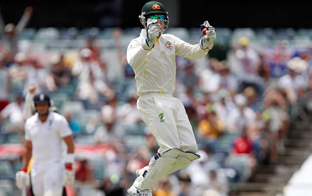 Australia's Brad Haddin jumps in the air after taking a catch on the fifth day of their Ashes cricket test match against England in Perth, Australia.