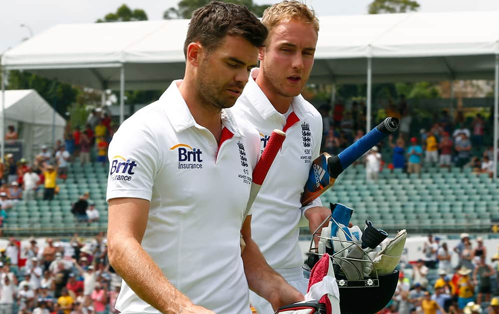 England's James Anderson and teammate Stuart Broad leave the ground after Australia defeated England in their Ashes cricket test match in Perth, Australia.