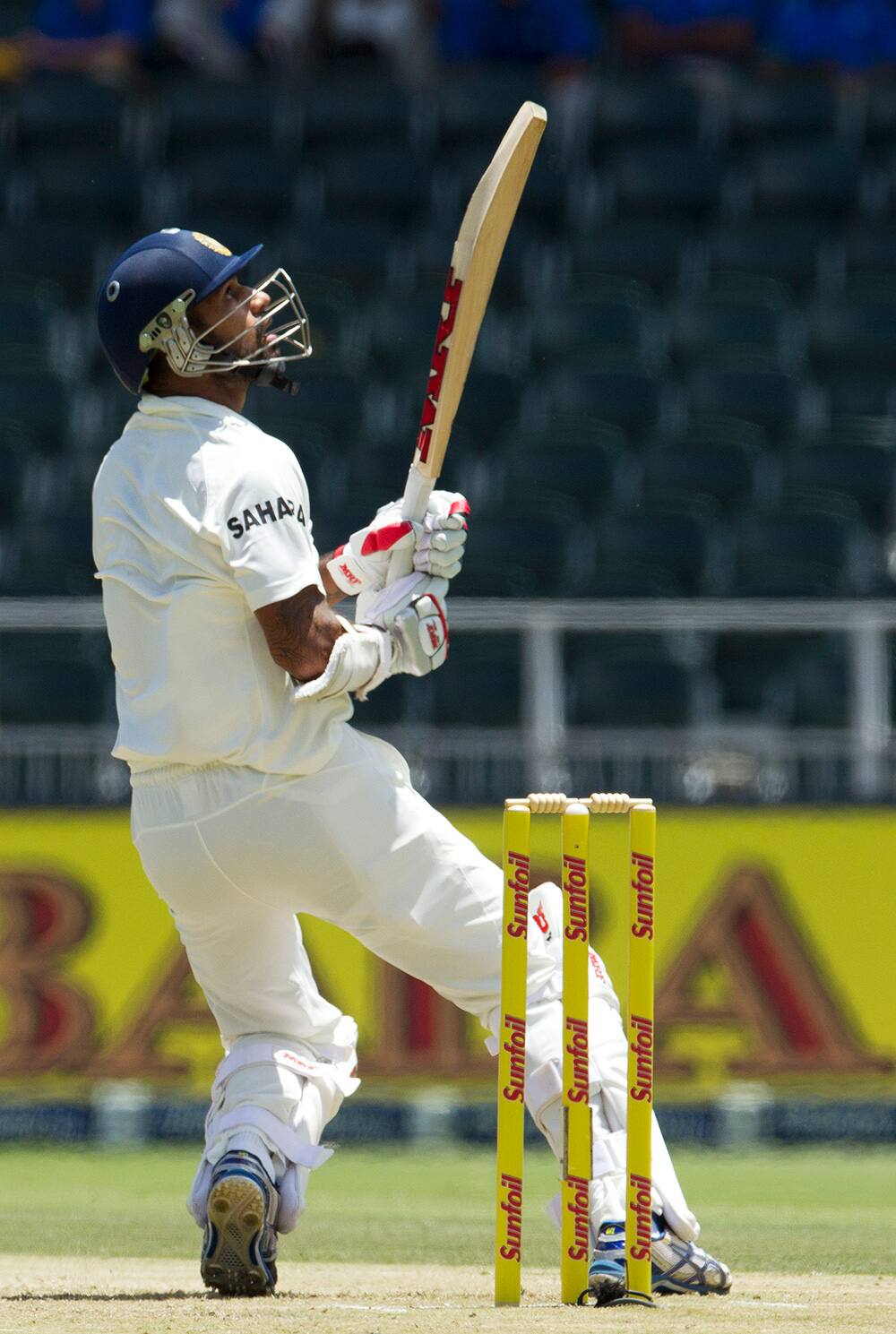 Shikhar Dhawan, watches his shot during the first day of their cricket test match against South Africa at Wanderers stadium in Johannesburg, South Africa.