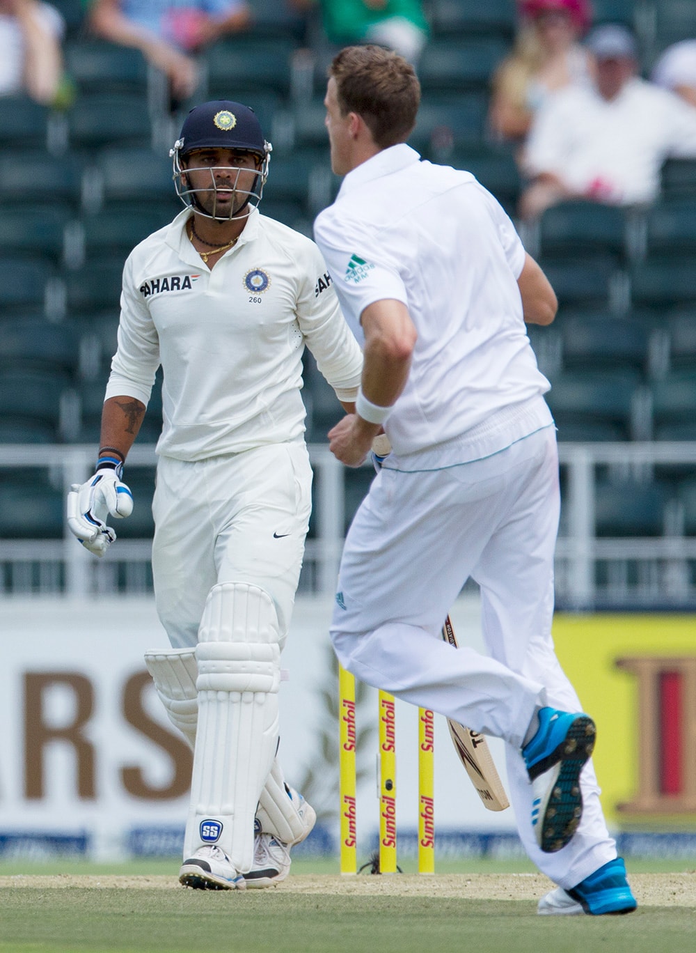 Murali Vijay watches as South Africa's bowler Morne Morkel celebrates his dismissal during the first day of their cricket test match at Wanderers stadium in Johannesburg, South Africa.