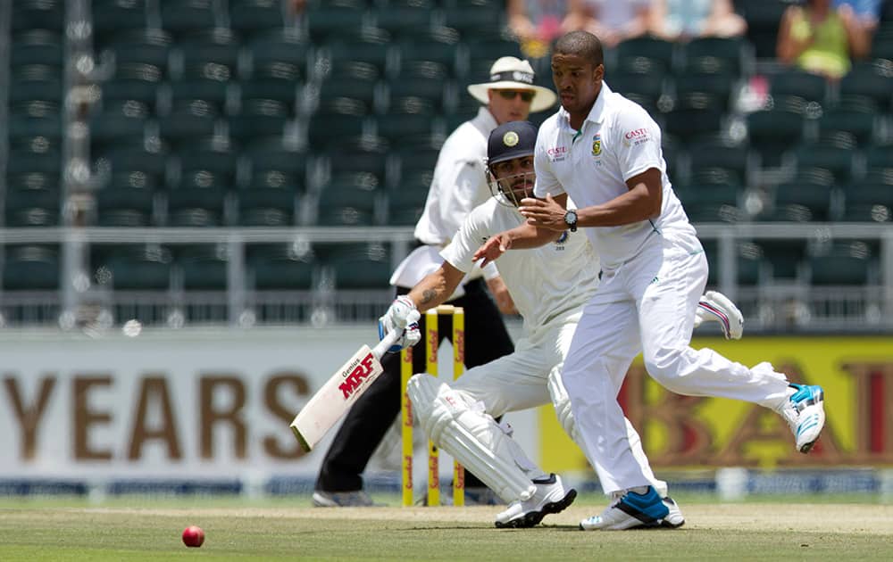 Vernon Philander attempt fielding off his own bowling as Virat Kohli runs back home during the first day of their cricket test match at Wanderers stadium in Johannesburg, South Africa.