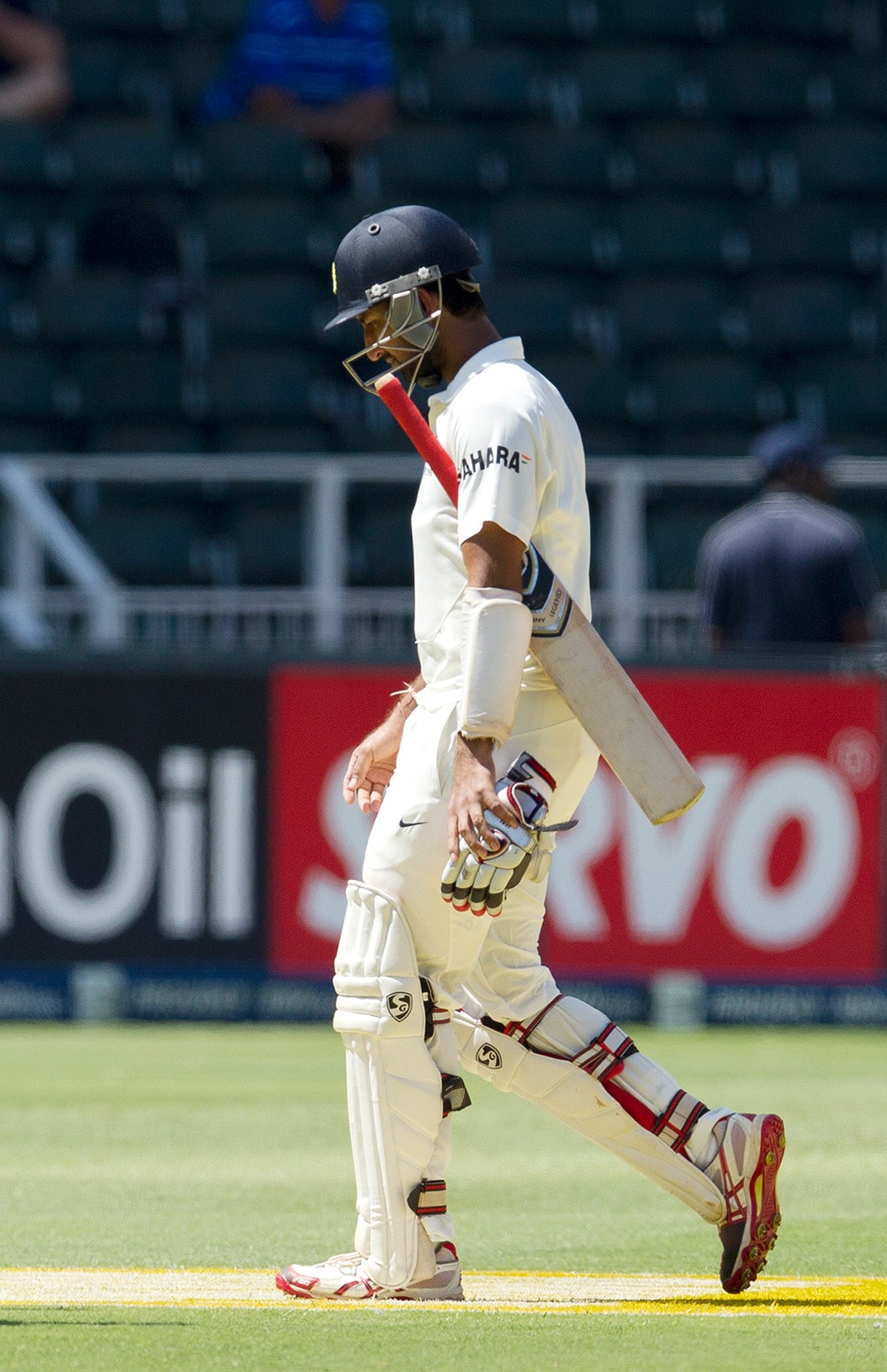 Cheteshwar Pujara, walks back to the pavilion after being dismissed for 25 runs during the first day of their cricket test match at Wanderers stadium in Johannesburg, South Africa.