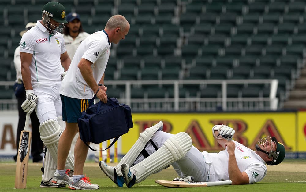 Graeme Smith lies in pain after being hit by a ball in his right leg, as the team medics attend to him, during the second day of their cricket test match against India at Wanderers stadium in Johannesburg, South Africa.