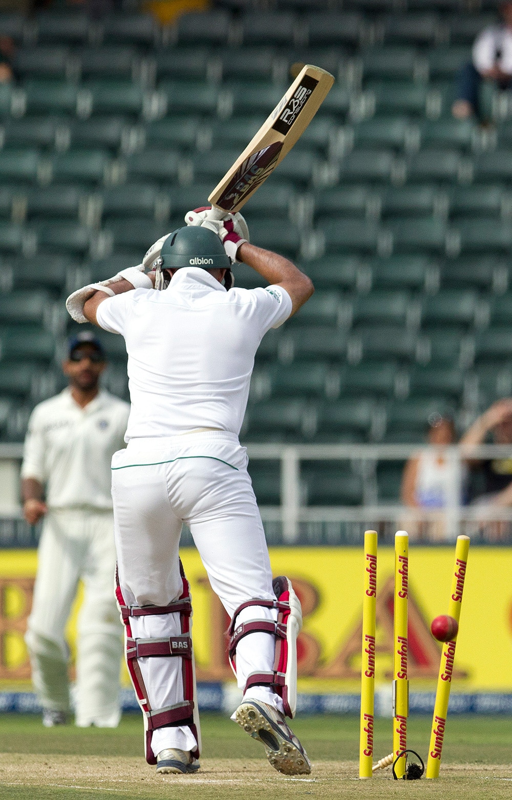 South Africa's batsman Hashim Amla, is bowled by India's bowler Ishant Sharma, for 36 runs during the second day of their cricket test match at Wanderers stadium in Johannesburg, South Africa.