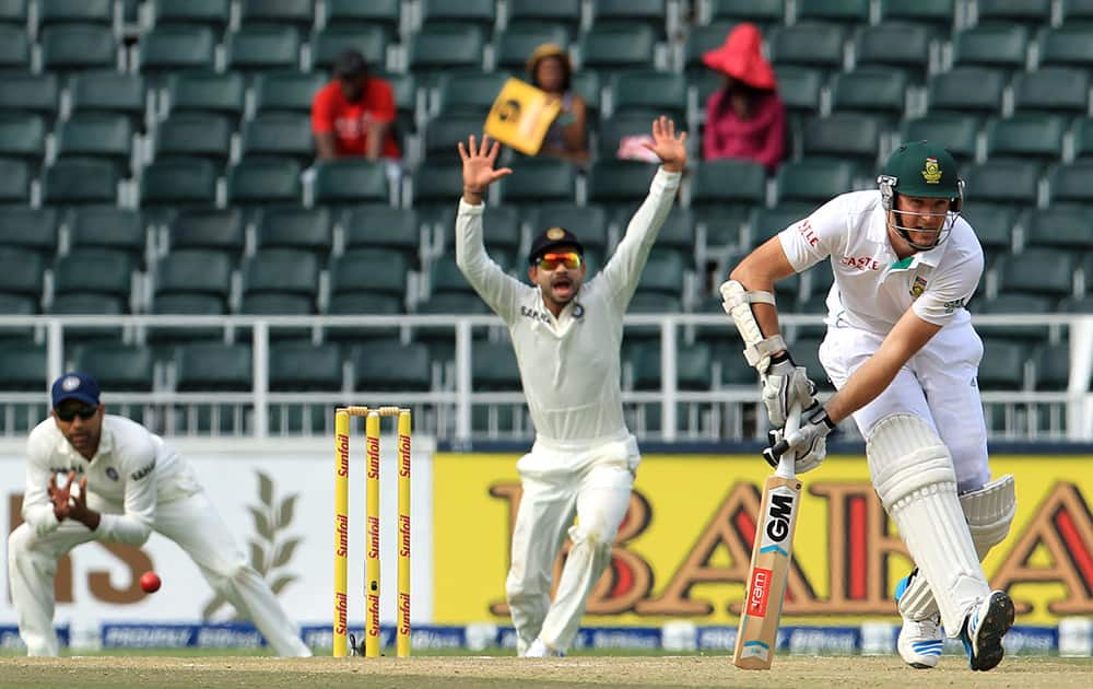 Graeme Smith looks on as India's fielder Virat Kohli successfully appeal for LBW during the second day of their cricket test match at Wanderers stadium in Johannesburg, South Africa.