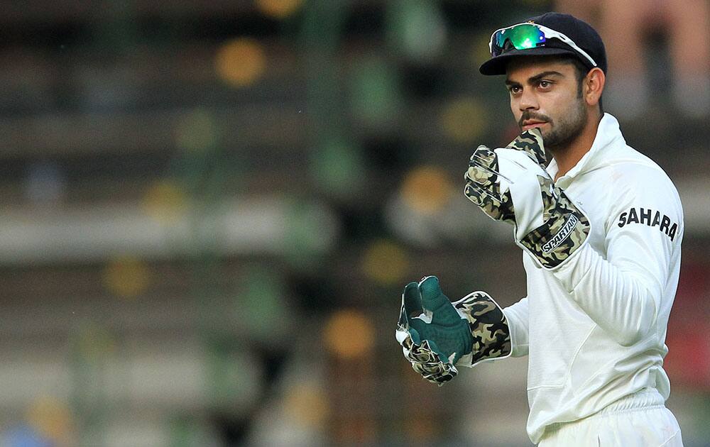 India's wicketkeeper Virat Kohli looks on during South Africa's 2nd innings on the fourth day of their cricket Test match at Wanderers stadium in Johannesburg, South Africa.