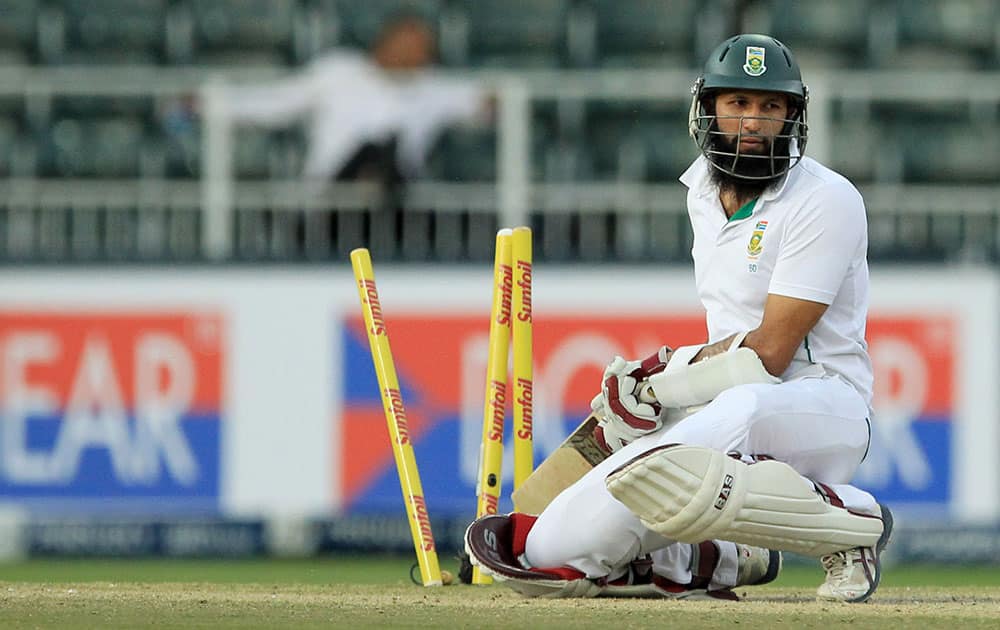 South Africa's batsman Hashim Amla looks on after being bowled by India's bowler Mohammad Shami, for 4 runs during their 2nd innings on the fourth day of their cricket test match at Wanderers stadium in Johannesburg, South Africa.