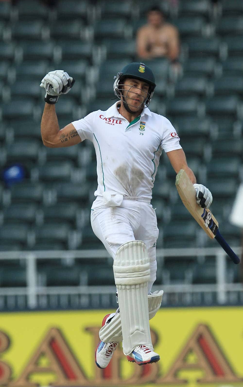 South Africa's batsman Francois du Plessis jumps as he celebrates a century during the fourth and final day of their cricket test match against India at Wanderers stadium in Johannesburg.