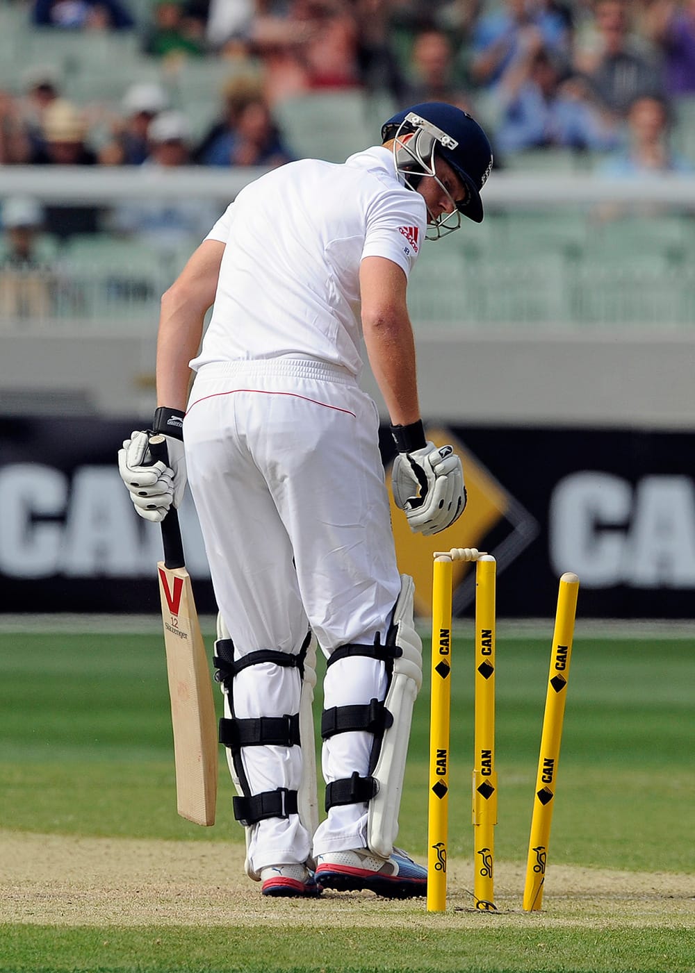 England's Jonny Bairstow looks at his stumps after being bowled by Australia's Mitchell Johnson on the first day of their Ashes cricket test match at the Melbourne Cricket Ground in Melbourne, Australia.