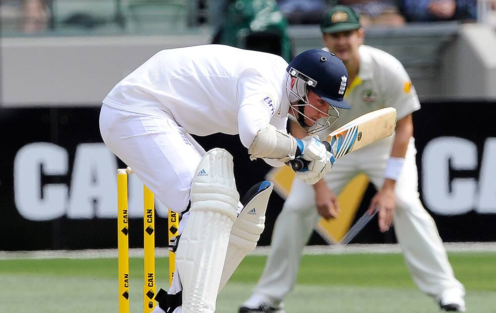 England's Stuart Broad ducks under a high delivery from Australia's Ryan Harris during their Ashes cricket test match at the Melbourne Cricket Ground in Melbourne, Australia.