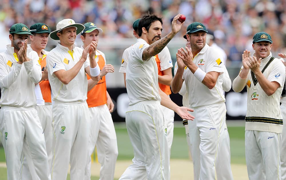 Australia's Mitchell Johnson holds up the ball after taking 5 wickets against England during their Ashes cricket test match at the Melbourne Cricket Ground in Melbourne, Australia.