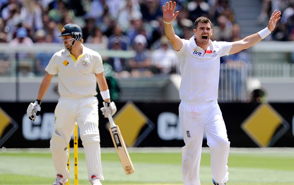 England's James Anderson raises his arms as he appeals for a decision on Australia's Shane Watson, left, during their Ashes cricket test match at the Melbourne Cricket Ground in Melbourne, Australia. England made 255 runs in their first innings. 