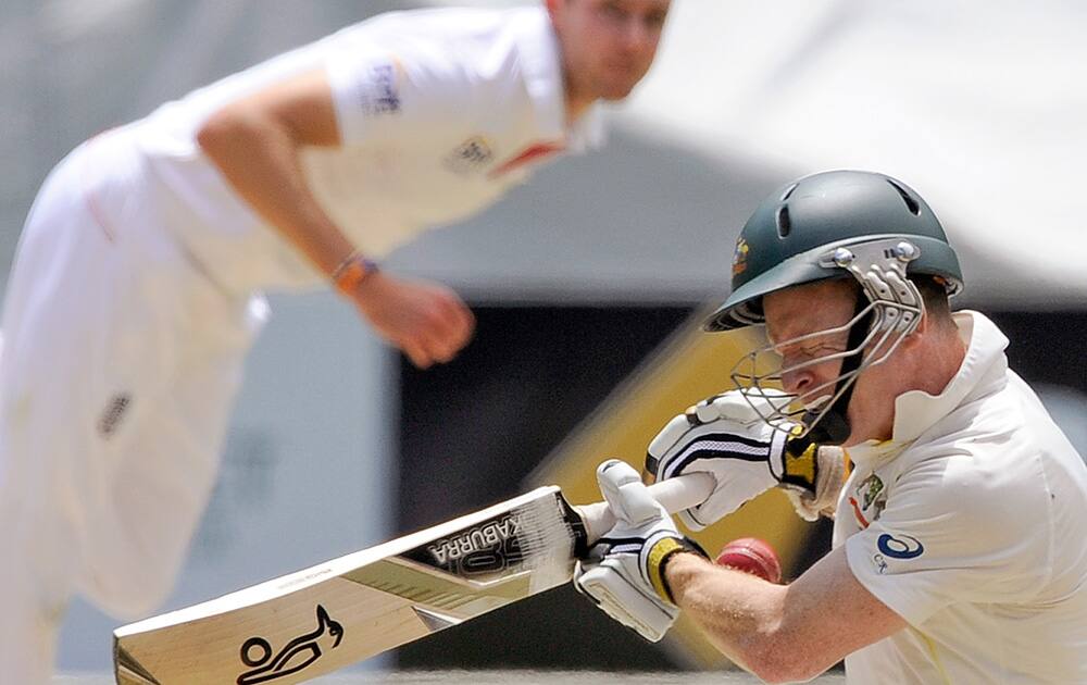 Australia's Chris Rogers is struck on the head off the bowling of England's Stuart Broad, left, during their Ashes cricket test match at the Melbourne Cricket Ground in Melbourne, Australia.