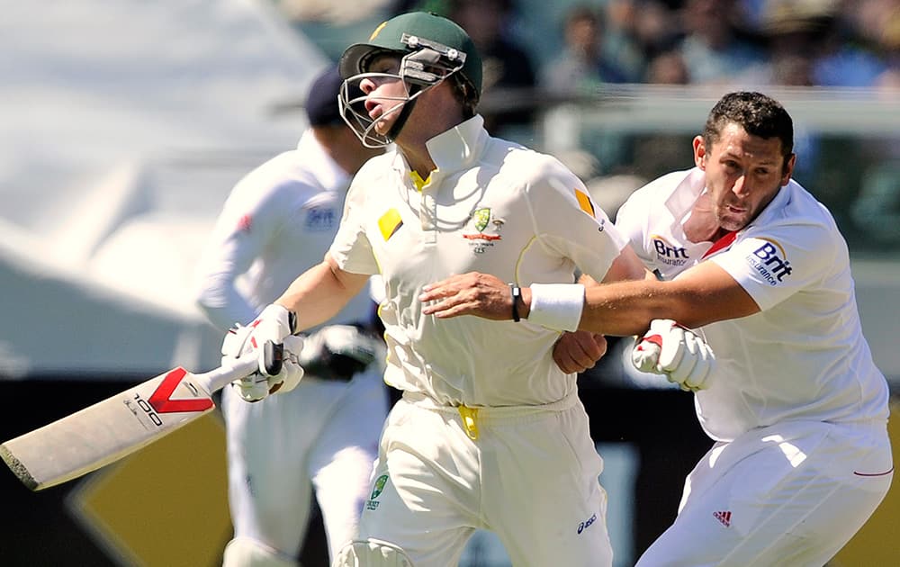 England's Tim Bresnan collides with Australia's Steve Smith during their Ashes cricket test match at the Melbourne Cricket Ground in Melbourne, Australia.