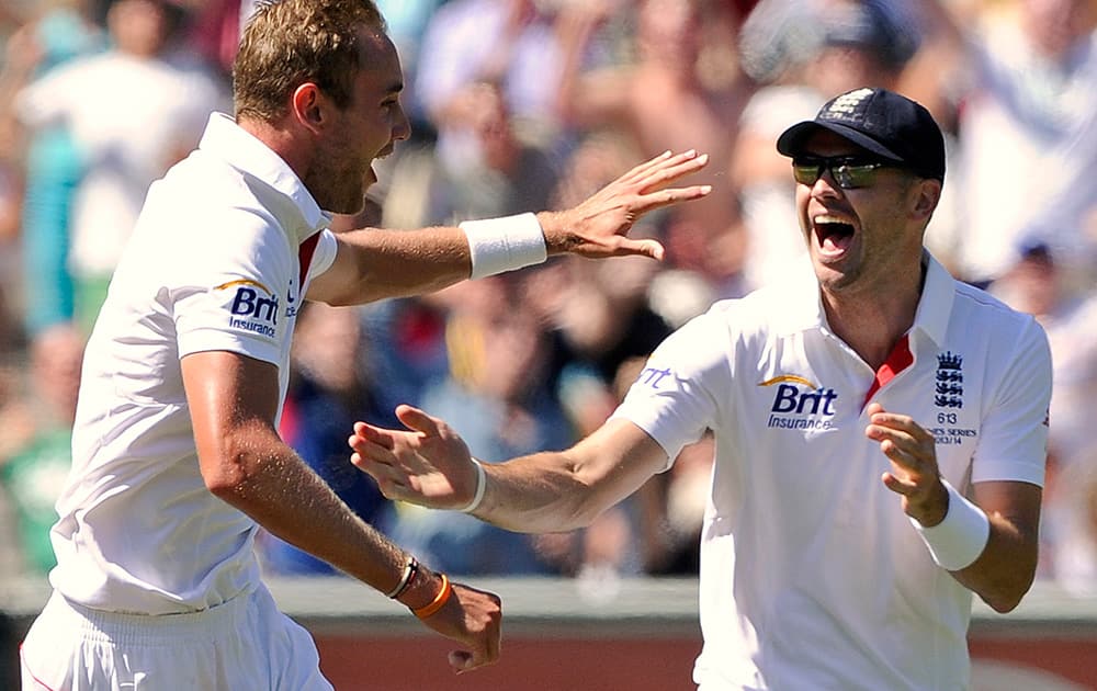 England's Stuart Broad celebrates with teammate James Anderson after taking the wicket of Australia's Steve Smith for 19 runs during their Ashes cricket test match at the Melbourne Cricket Ground in Melbourne, Australia.