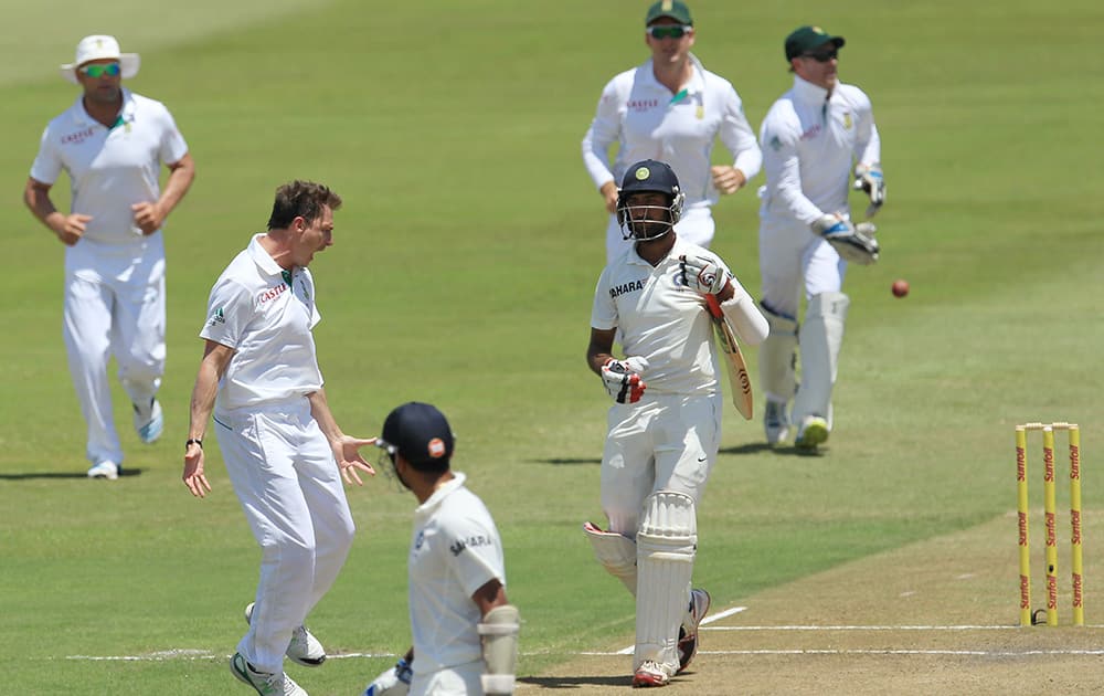 Dale Steyn celebrates after dismissing Cheteshwar Pujara for 70 runs during second day of their cricket test match at Kingsmead stadium, Durban, South Africa.