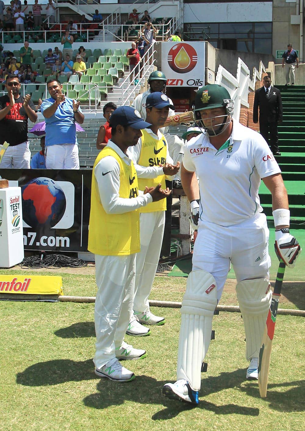 South Africa's batsman Jacques Kallis, right, walks to the field as India's players form a guard of honor on second day of their cricket test match at Kingsmead stadium, Durban, South Africa.
