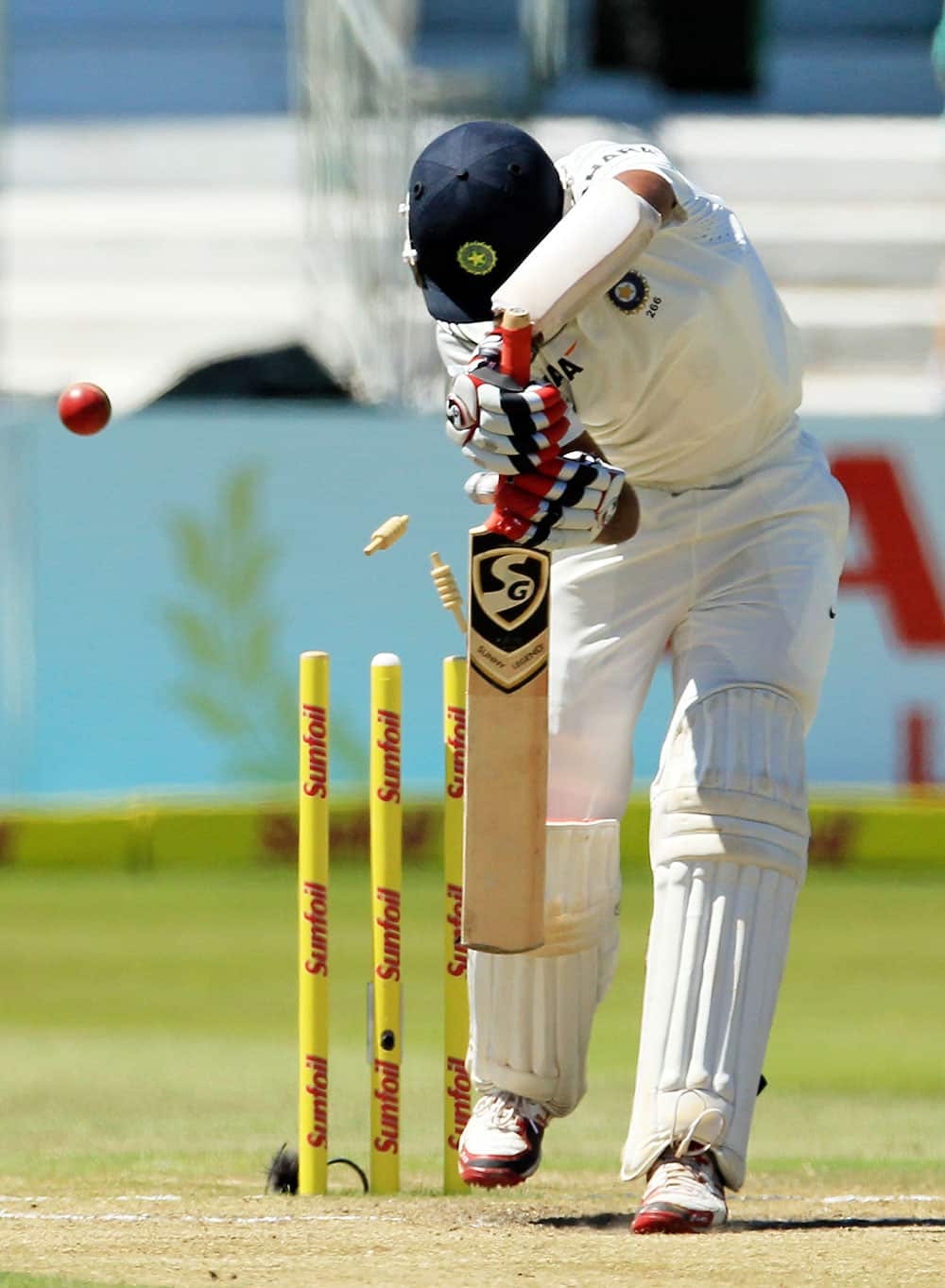 India's batsman Cheteshwar Pujara is bowled by South Africa's bowler Dale Steyn, for 32 runs on the firth and final day of their cricket test match at Kingsmead stadium in Durban, South Africa.