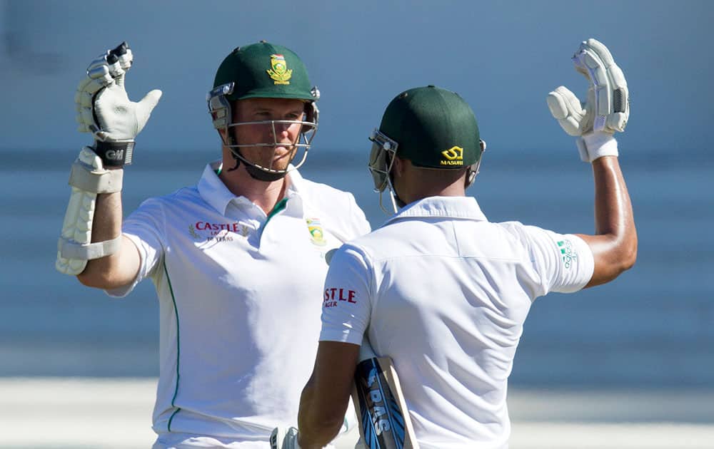 South Africa's captain Graeme Smith, left, celebrates with teammate Alviro Petersen after scoring the winning runs of their fifth and final day of their cricket test match against India at Kingsmead stadium, Durban, South Africa.
